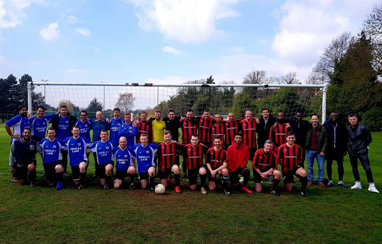 Both Old Whits teams and their supporters lined up together in front of a goal at the 2019 Club Day